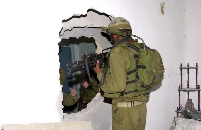 The Army knocks holes from one house to the next as they search in the camp. (Photo: Nasser Ishtayeh)
